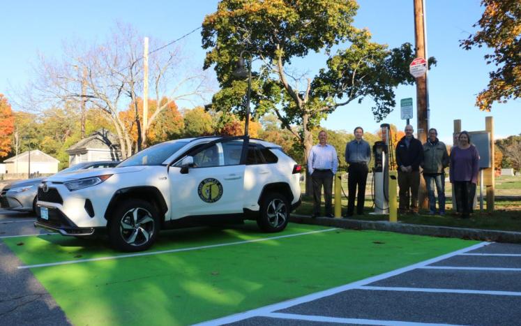 Photo of Commissioners and Employees standing next to new EV charging station